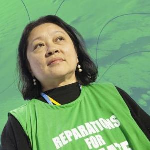 Lidy Nacpil met hesje 'Reparations for Climate Debt'