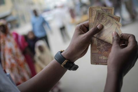 A man counts Somali shilling notes having just exchanged US Dollars